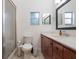 Bathroom features wood cabinet vanity and a framed mirror at 1505 Magnolia Ave, Sanford, FL 32771