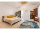 Bright bedroom featuring vaulted ceiling, tile flooring, decorative rug, walk in closet, and ensuite bath at 1505 Magnolia Ave, Sanford, FL 32771