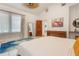 Bright bedroom featuring vaulted ceiling, tile flooring, decorative rug, and stylish furniture at 1505 Magnolia Ave, Sanford, FL 32771