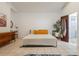 Bright bedroom featuring tile flooring, ensuite bath, a bright window, and stylish furniture at 1505 Magnolia Ave, Sanford, FL 32771