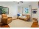 Bright bedroom with hardwood floors, daybed and leather recliner at 1505 Magnolia Ave, Sanford, FL 32771