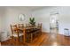 Cozy dining area with wood table, chairs and bench, hardwood floors and ample light at 1505 Magnolia Ave, Sanford, FL 32771