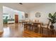 Bright dining area adjacent to living room features hardwood floors, leading to an open concept living space at 1505 Magnolia Ave, Sanford, FL 32771