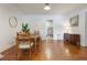Cozy dining area with wood table, chairs and bench, hardwood floors and ample light at 1505 Magnolia Ave, Sanford, FL 32771