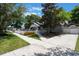 Property featuring a driveway and well-kept lawn bordered by a classic white picket fence and manicured landscaping at 1505 Magnolia Ave, Sanford, FL 32771