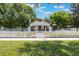 Inviting home featuring a well-maintained lawn, classic white picket fence, and a charming walkway to the front door at 1505 Magnolia Ave, Sanford, FL 32771