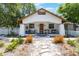 Charming home featuring a welcoming front porch, decorative stone path, and a meticulously landscaped front yard at 1505 Magnolia Ave, Sanford, FL 32771