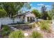 Beautifully landscaped front yard featuring a white picket fence, lush greenery, and a stone path leading to the home at 1505 Magnolia Ave, Sanford, FL 32771