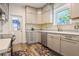 Well-lit kitchen featuring stainless steel appliances, white cabinets and modern countertops at 1505 Magnolia Ave, Sanford, FL 32771