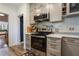Updated kitchen features stainless steel appliances, stylish cabinets, subway tile backsplash, and modern countertops at 1505 Magnolia Ave, Sanford, FL 32771