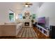 Bright living room features a cozy fireplace, hardwood floors, and modern entertainment center at 1505 Magnolia Ave, Sanford, FL 32771
