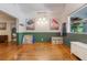 Spacious living room featuring beautiful hardwood floors and a pop of modern color accenting the open layout at 1505 Magnolia Ave, Sanford, FL 32771