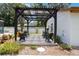 Charming outdoor patio featuring a pergola, stylish seating, and beautiful landscaping at 1505 Magnolia Ave, Sanford, FL 32771