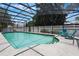 Sparkling pool with screen enclosure, clear blue water, and lounge chairs for relaxing at 1505 Magnolia Ave, Sanford, FL 32771