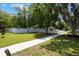 Spacious lawn featuring mature trees, a sidewalk, and a white fence surrounding the perimeter of the property at 1505 Magnolia Ave, Sanford, FL 32771