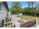 The backyard features a fire pit, an above ground pool and wood deck, and mature trees at 16 Lake Drive, Debary, FL 32713