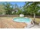 This backyard features an above ground pool, shed, and ample privacy from mature trees at 16 Lake Drive, Debary, FL 32713