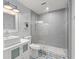 Stylish bathroom featuring a modern vanity, glass-enclosed shower, and patterned tile flooring at 16 Lake Drive, Debary, FL 32713