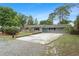 Well-manicured single-story home, highlighted by a spacious driveway and mature landscaping at 16 Lake Drive, Debary, FL 32713