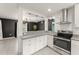 Modern kitchen with granite countertops, stainless steel appliances, and tile backsplash at 16 Lake Drive, Debary, FL 32713
