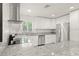 Updated kitchen featuring stainless steel appliances and granite countertops at 16 Lake Drive, Debary, FL 32713
