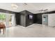 Modern living room with sleek tile floors, a ceiling fan, and glass doors to the backyard at 16 Lake Drive, Debary, FL 32713