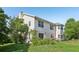 Spacious backyard featuring a two-story home with a chimney and lush landscaping at 16249 Se 162Nd Ct, Weirsdale, FL 32195