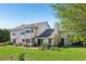 Lush backyard with patio, chimney, and access to garage at 16249 Se 162Nd Ct, Weirsdale, FL 32195