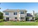 Large backyard with patio, sliding glass doors, and beautiful two-story home at 16249 Se 162Nd Ct, Weirsdale, FL 32195