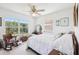 Bright bedroom with large window, ceiling fan, and white walls, needs arrangement and cleaning at 16249 Se 162Nd Ct, Weirsdale, FL 32195