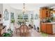Bright breakfast nook with large windows and a charming chandelier at 16249 Se 162Nd Ct, Weirsdale, FL 32195