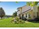 Exterior of property featuring beautiful landscaping and a view of the lake at 16249 Se 162Nd Ct, Weirsdale, FL 32195