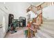 Spacious foyer with tile floors, wooden staircase, and high ceilings at 16249 Se 162Nd Ct, Weirsdale, FL 32195