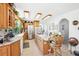 Bright kitchen featuring light wood cabinets, an island and tile floors at 16249 Se 162Nd Ct, Weirsdale, FL 32195
