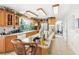 Bright kitchen with stainless steel appliances, wooden cabinets, and a long island with a bar top at 16249 Se 162Nd Ct, Weirsdale, FL 32195