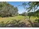 A lush green pasture with shade trees, offering a peaceful and natural setting at 16249 Se 162Nd Ct, Weirsdale, FL 32195