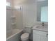 Well-lit bathroom with clean white fixtures, a shower-tub combo, and a modern vanity at 1800 Coriander Dr, Kissimmee, FL 34759