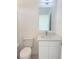 Bright bathroom showcasing modern vanity with sink, mirror, and white toilet at 1800 Coriander Dr, Kissimmee, FL 34759
