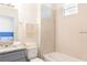 Clean bathroom with shower over tub, granite countertop vanity, and neutral tile at 1800 Coriander Dr, Kissimmee, FL 34759