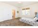 Cozy bedroom with large windows, neutral carpet, and ensuite bathroom access at 1800 Coriander Dr, Kissimmee, FL 34759