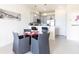 Open dining area with gray chairs, glass table, and kitchen access, perfect for entertaining at 1800 Coriander Dr, Kissimmee, FL 34759