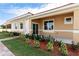 Charming single-story home with a terracotta roof, manicured lawn, and inviting front porch at 1800 Coriander Dr, Kissimmee, FL 34759