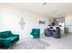 Open-concept living space with modern furnishings, including an adjacent dining area and kitchen at 1800 Coriander Dr, Kissimmee, FL 34759