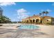 Beautiful community pool with a Mediterranean-style clubhouse, complemented by tropical palm trees and inviting lounge chairs at 1800 Coriander Dr, Kissimmee, FL 34759