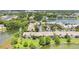 An aerial view of lakeside condominiums, lush greenery, and water views from many angles at 200 Maitland Ave # 122, Altamonte Springs, FL 32701