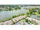 An aerial view of residential building by lake, showcasing landscaping, parking and lake access at 200 Maitland Ave # 122, Altamonte Springs, FL 32701