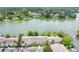 An aerial view of lakeside residential building surrounded by lush trees and a parking lot at 200 Maitland Ave # 122, Altamonte Springs, FL 32701