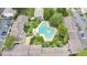 Aerial view showcasing a unique pool surrounded by condos and lush landscaping at 200 Maitland Ave # 122, Altamonte Springs, FL 32701