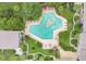 Aerial view showcasing a unique pool with lounge chairs surrounded by green landscaping at 200 Maitland Ave # 122, Altamonte Springs, FL 32701