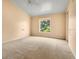 Bright bedroom with a window overlooking mature trees and a ceiling fan at 200 Maitland Ave # 122, Altamonte Springs, FL 32701